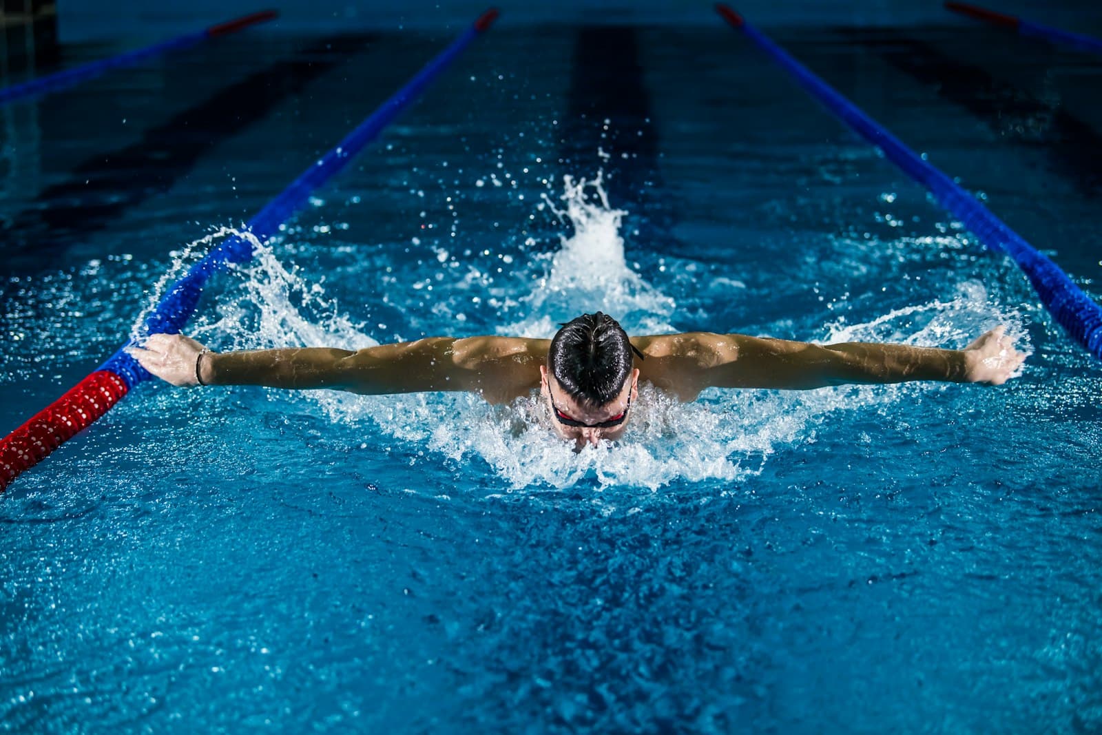 A swimmer pushing off the pool wall